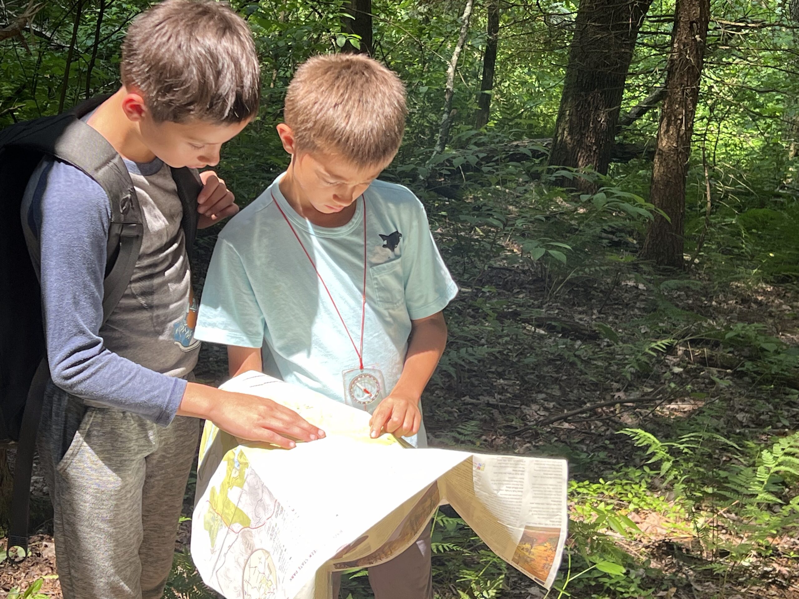 Orienteering boys reading a map